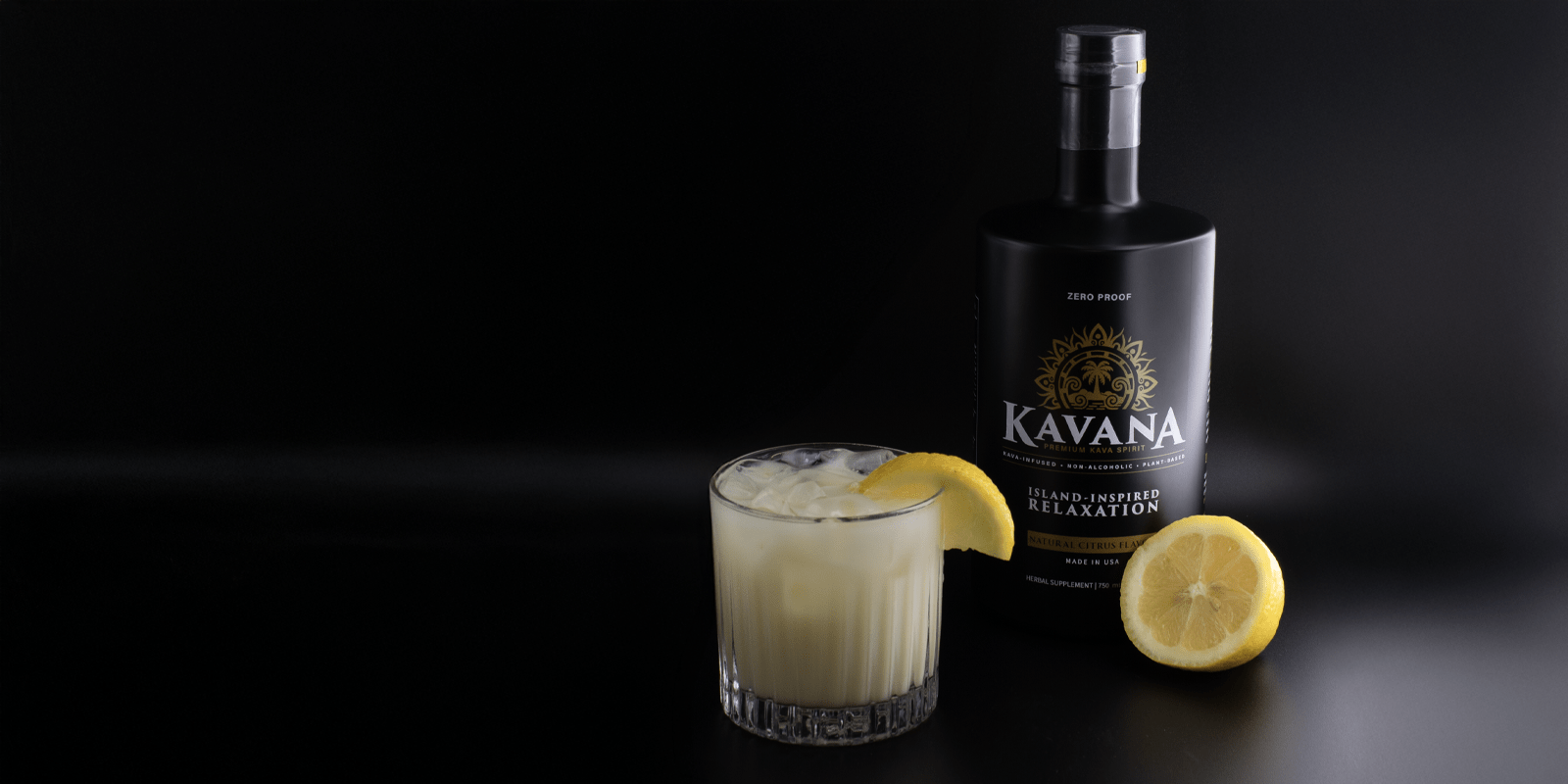 KAVANA non-alcoholic spirit bottle with citrus garnish and crafted cocktail on a dark background